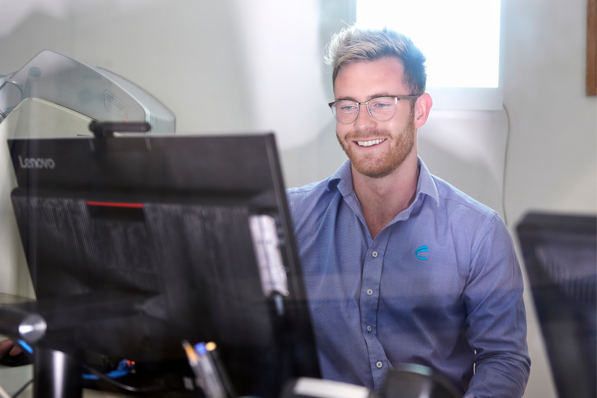 Man Looking At Computer Screen Happily | Australia Radiology Clinic | Capital Radiology